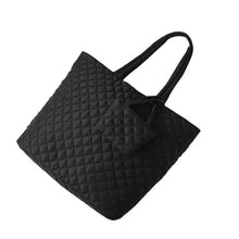 Load image into Gallery viewer, Angled flat view of Nollia Bethany black quilted commuter tote with mini tote bag