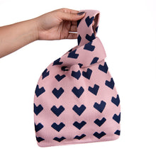 Load image into Gallery viewer, Sweetheart knit tote featuring bold purple hearts on a soft pink base
