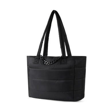 Angled view of Nollia Aime black nylon commuter tote with chain accent.