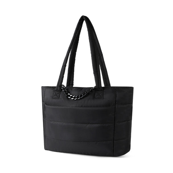Angled view of Nollia Aime black nylon commuter tote with chain accent.