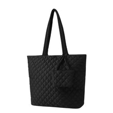 Load image into Gallery viewer, Angled view of Nollia Bethany black quilted tote with mini tote add-on
