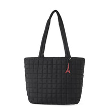 Load image into Gallery viewer, Black quilted nylon tote bag with red Eiffel Tower charm, front view
