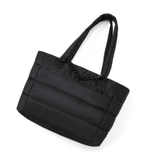 Load image into Gallery viewer, Flat angled view of Nollia Aime black nylon commuter tote with chain detail.
