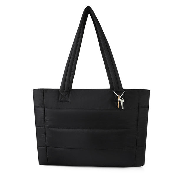 Front view of black quilted commuter tote bag with padded straps and key charm.