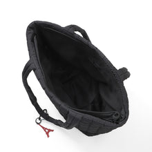 Load image into Gallery viewer, Interior view of black quilted tote bag with zippered pocket
