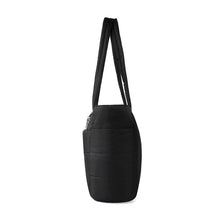 Load image into Gallery viewer, Side profile of black quilted commuter tote bag showing structured design.
